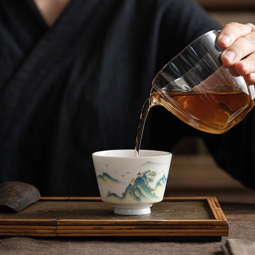 Handmade Buddhist ceramic tea cup featuring sacred lotus flower imagery and Eastern philosophical symbolism