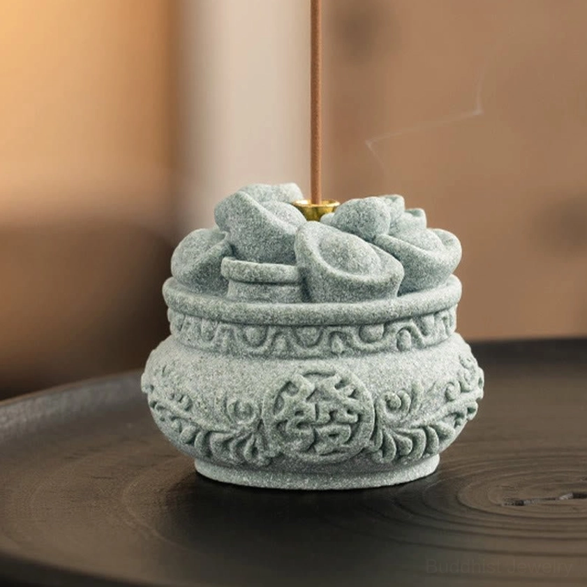 Front three-quarter view of matte gray sandstone incense burner with standing incense stick
