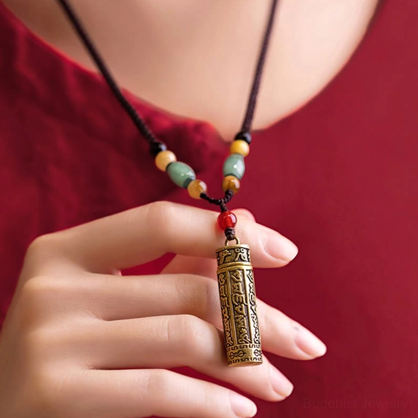 Buddhist scripture carved brass cylindrical pendant necklace worn close to heart