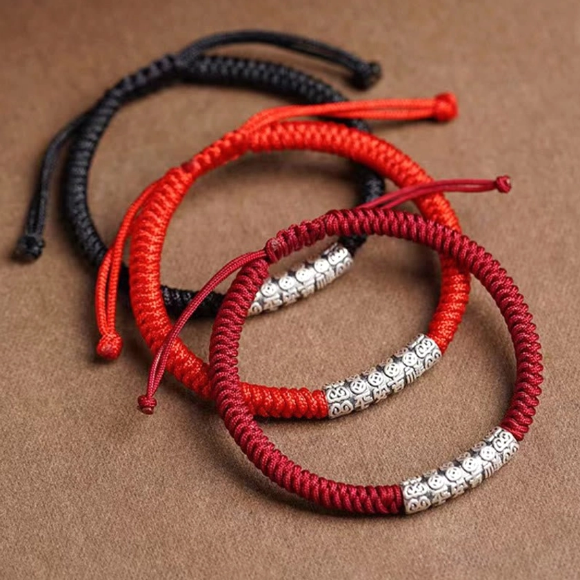 Set of three Buddhist sterling silver string bracelets in black, red, and dark red with engraved mantras