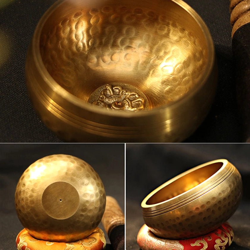 Handcrafted Buddhist meditation singing bowl with orange embroidered silk cushion and wooden mallet for authentic sound healing ceremony