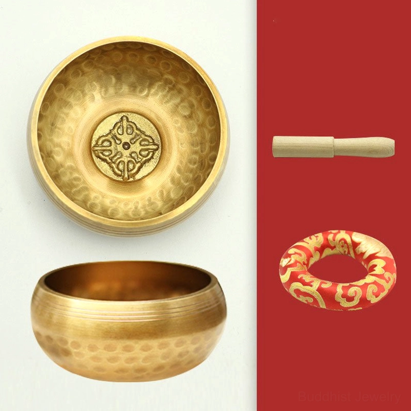 Buddhist singing bowl with dimpled hammered brass finish and red-gold embroidered silk cushion, portable meditation instrument side view