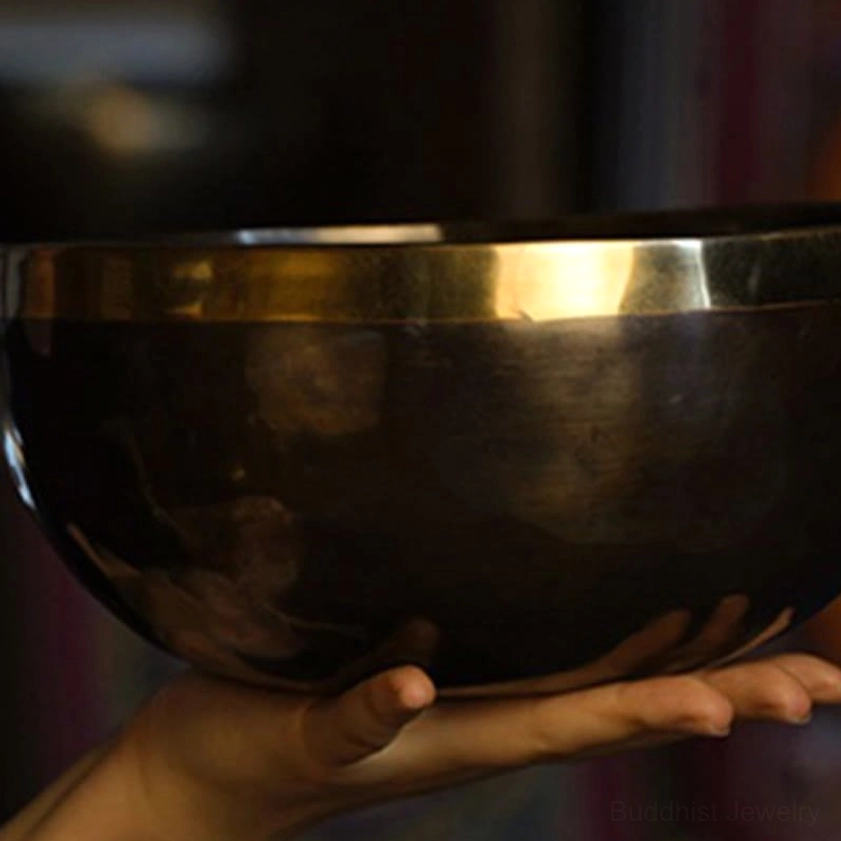 Buddhist singing bowl displaying natural hammer marks and oxidation variations characteristic of authentic handmade craftsmanship