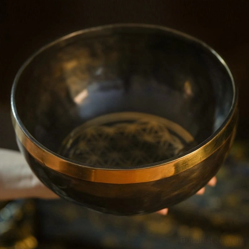 Top-down overhead view of handmade Buddhist singing bowl showing etched geometric interior pattern and polished gold rim border