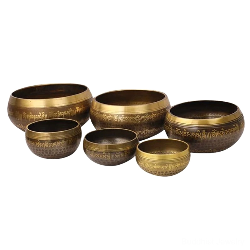 Buddhist singing bowl in natural outdoor setting, displaying bronze patina and golden Sanskrit text, handcrafted meditation sound tool