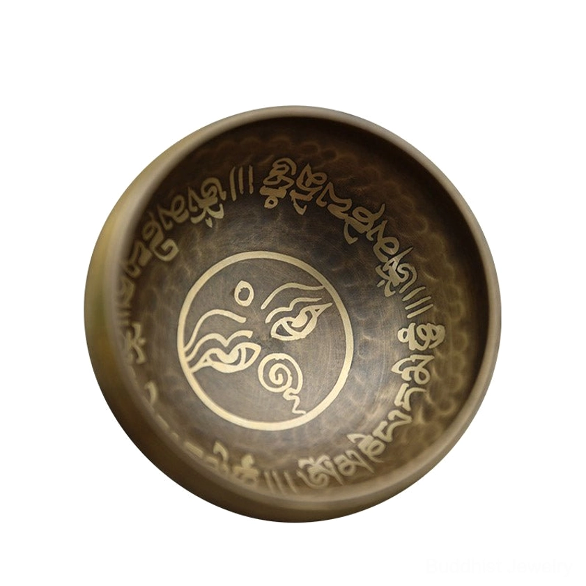 Buddhist singing bowl spiritual healing tool for yoga and chakra alignment, showing ceremonial engraved patterns