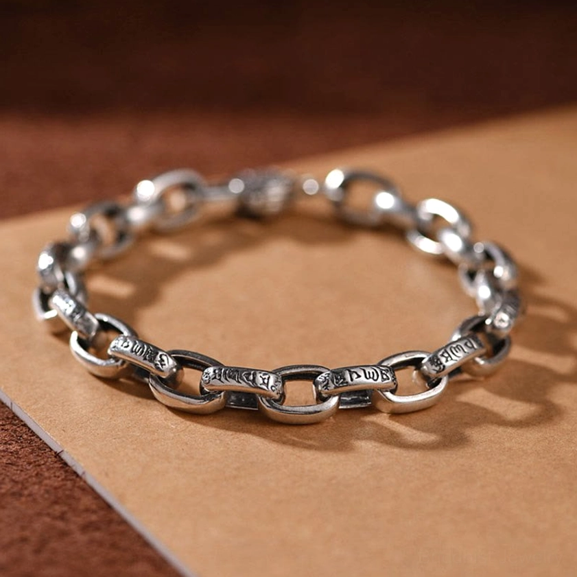 Full overhead view of sterling silver Om Mani Padme Hum bracelet showing complete looped chain with engraved link segments
