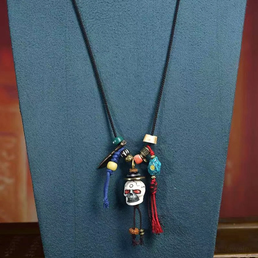 Product promotional poster for Buddhist skull bone necklace with Himalayan spiritual art