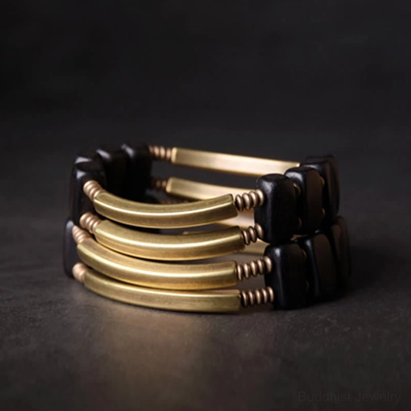 Handcrafted ebony wood brass bracelet symbolizing Buddhist spiritual practice and inner peace