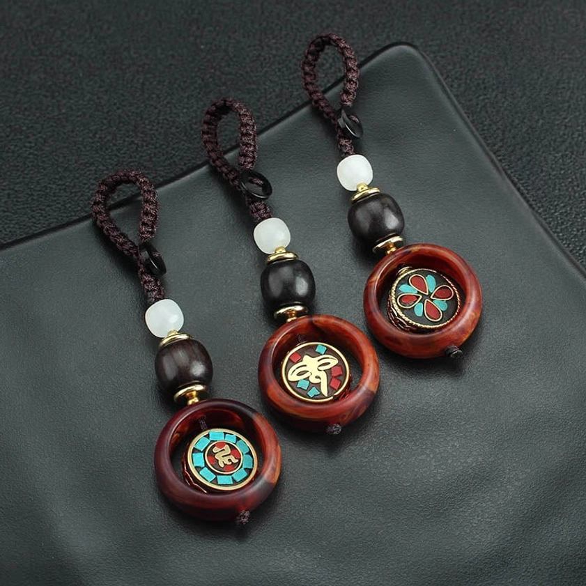 Ebony wood Buddhist keychain displayed with lifestyle context showing spiritual mindfulness and protective daily companion use