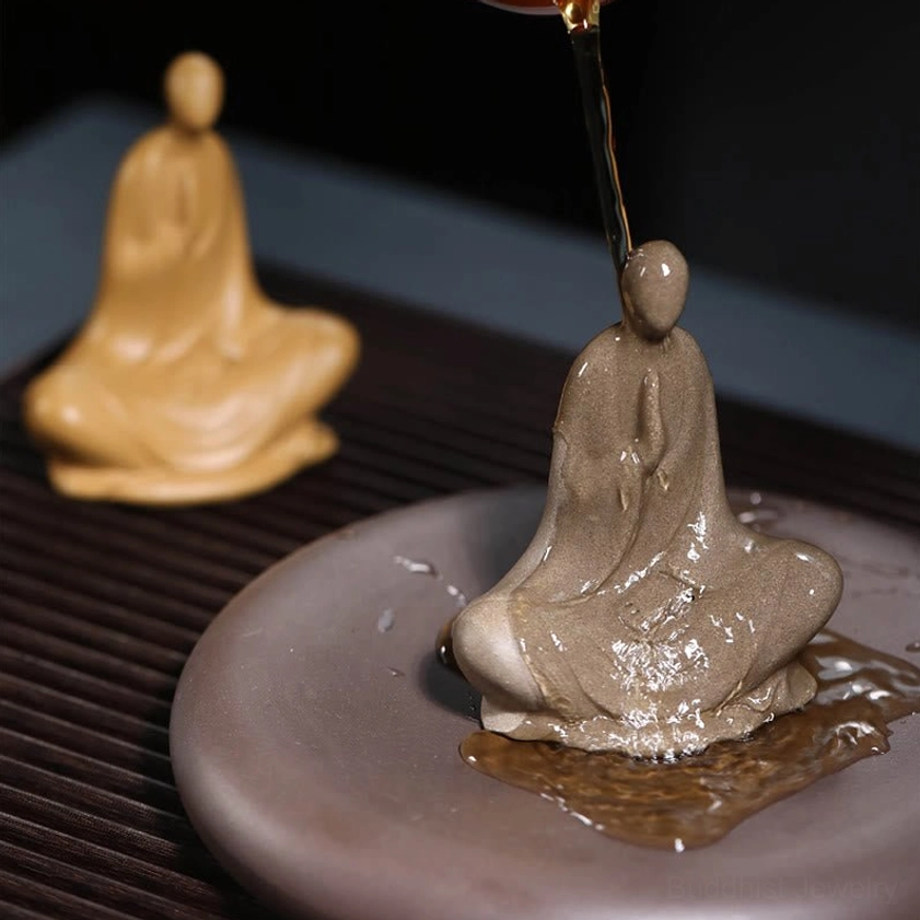 Buddhist statue ceramic meditation - prayer hands pose on decorative reddish-brown base