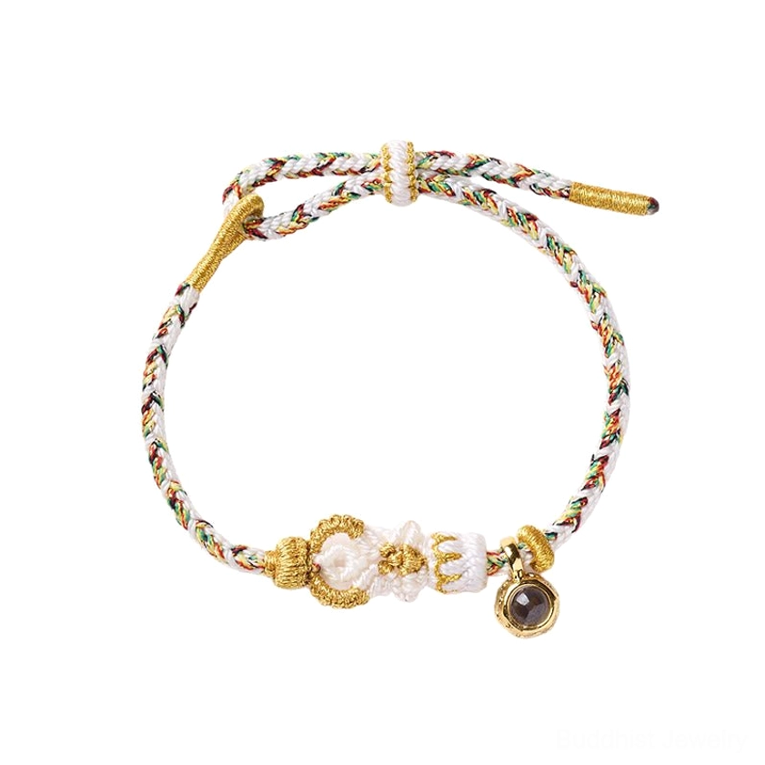 Close-up detail of Buddhist string bracelet adjustable drawstring mechanism and knot construction