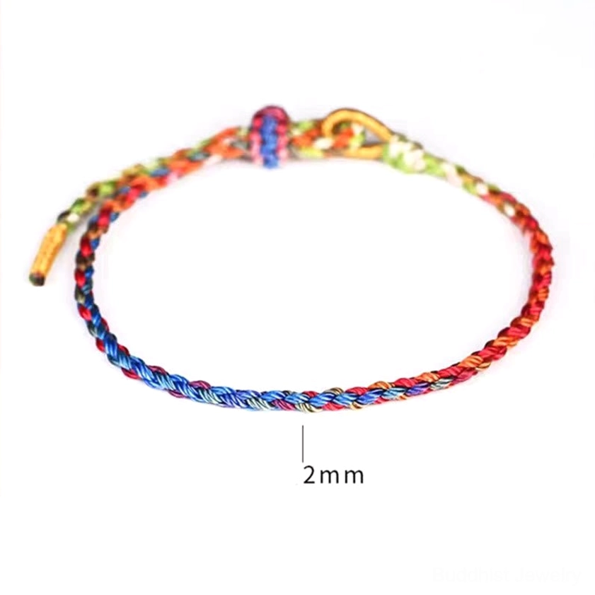 Multicolor Buddhist string bracelet with red, blue, yellow, green and gold threads, 2mm thickness detail shot, adjustable knot