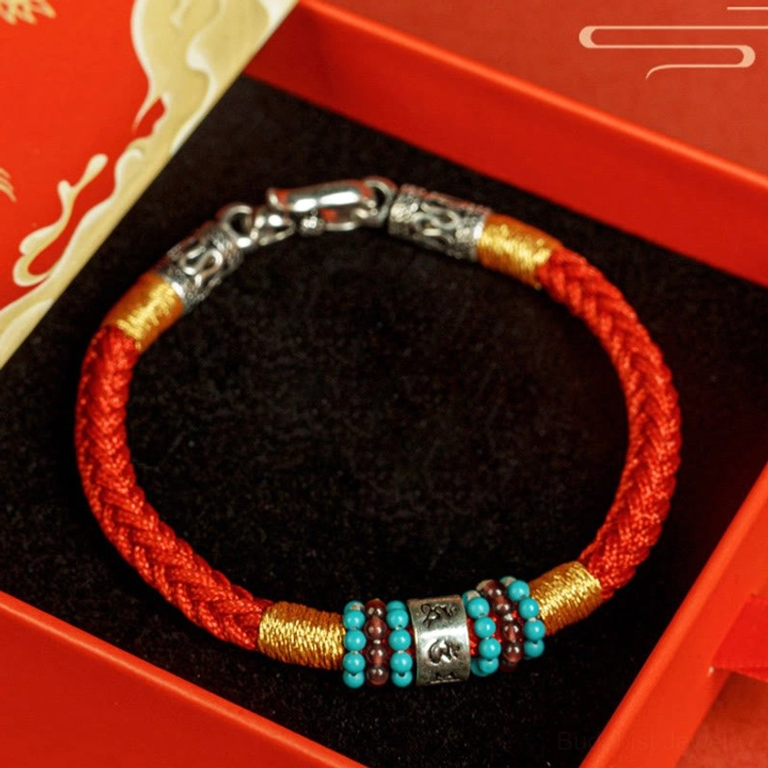 Red Buddhist string bracelet in luxury gift box with black velvet lining, ready for gifting