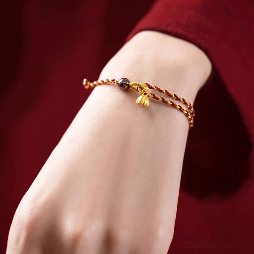 Red gold lotus charm bracelet worn on wrist showing daily wear and fit