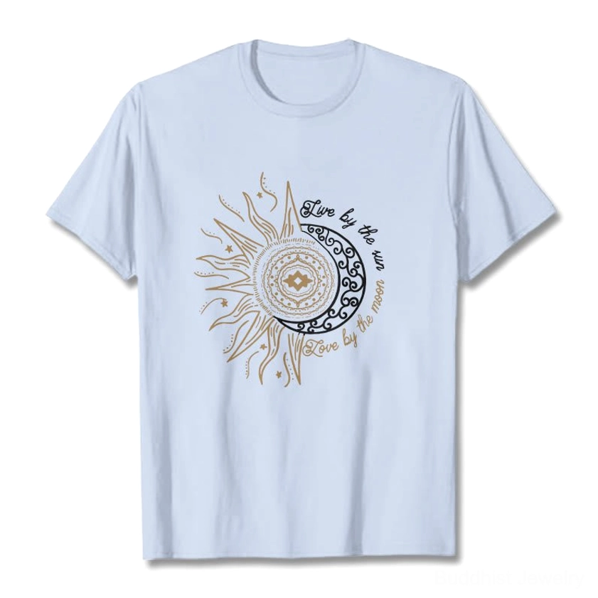 Light cyan Live by the Sun Love by the Moon Buddhist t-shirt flat lay with gold celestial graphic