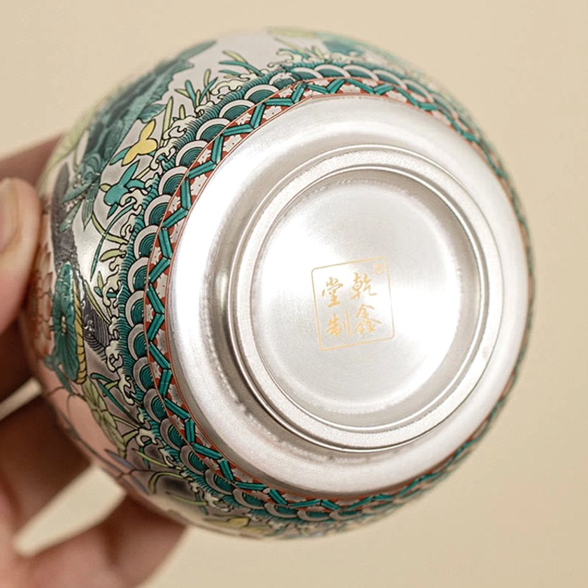 Bottom base of handcrafted Buddhist tea cup with gold maker's mark stamp and wave pattern border detail