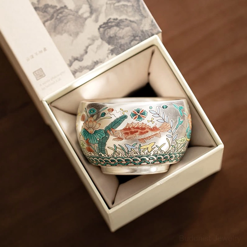 Buddhist tea cup in elegant white gift box with traditional landscape print on wooden tabletop display