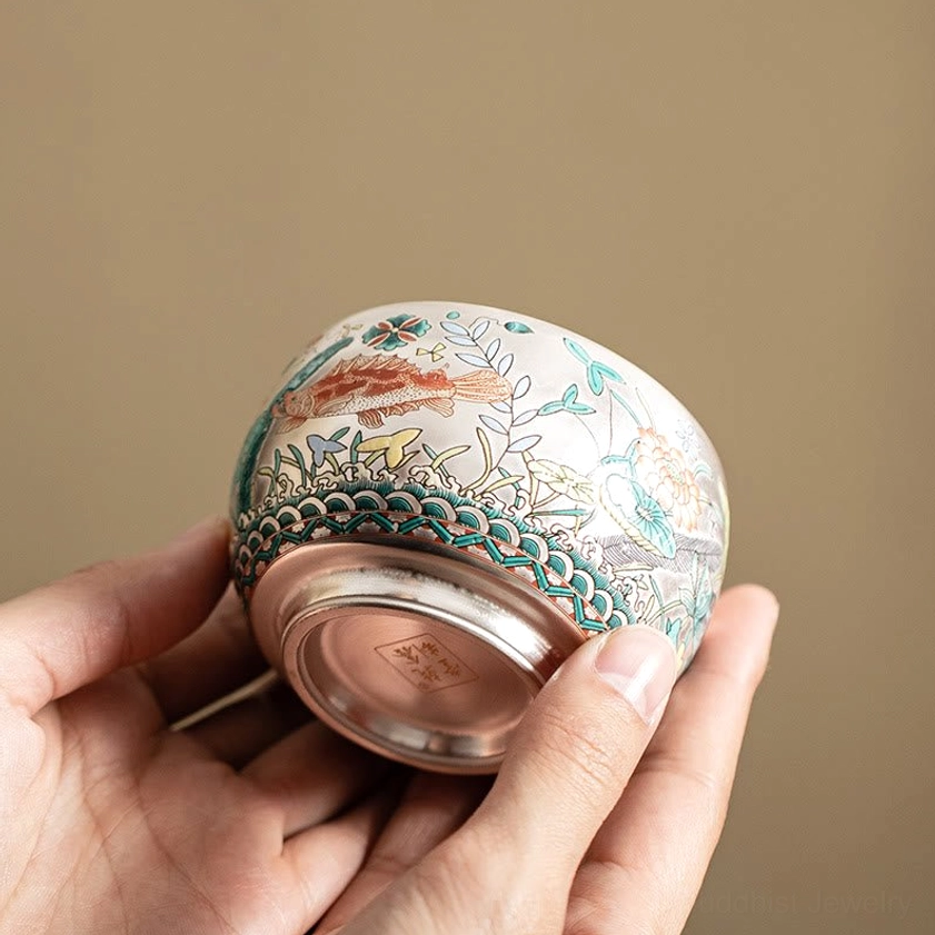 Buddhist ceramic kung fu tea cup side-bottom holding view displaying decorated exterior and authentic artisan base