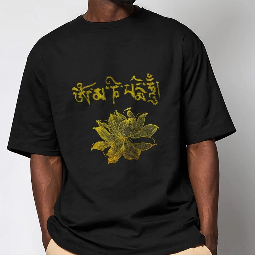 Close-up detail of golden Sanskrit and lotus flower print on black Buddhist graphic t-shirt - spiritual clothing design detail