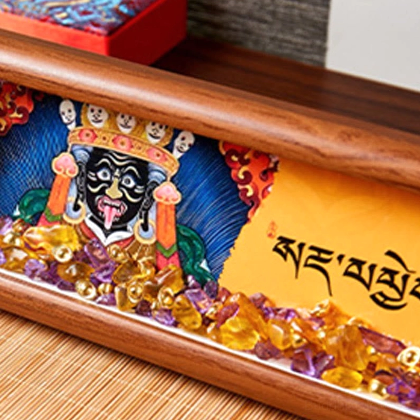 Close-up detail of thangka frame showing dharma deity fierce black face with ornate crown and crystal embellishments