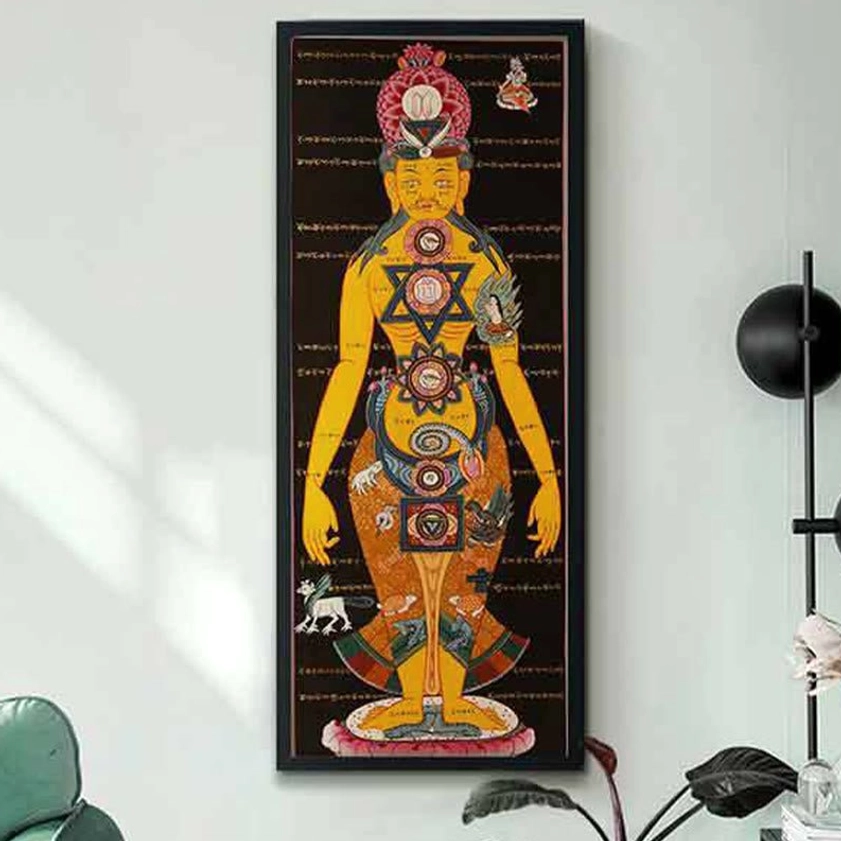 Buddhist thangka scroll displayed in modern minimalist living room with wall lamp and green plants spiritual decor