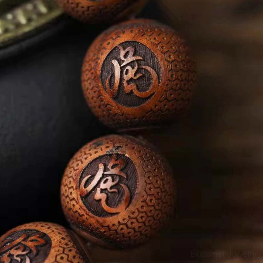 Ultra close-up macro shot of hand-carved Buddhist tiger motif on rosewood bead with fine surface texture and natural finish