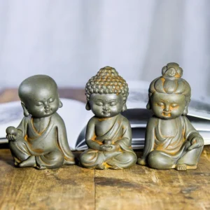 Rust finish Buddhist trinity statue set featuring Ksitigarbha Avalokitesvara and Tathagata bodhisattva meditation sculptures on wooden display