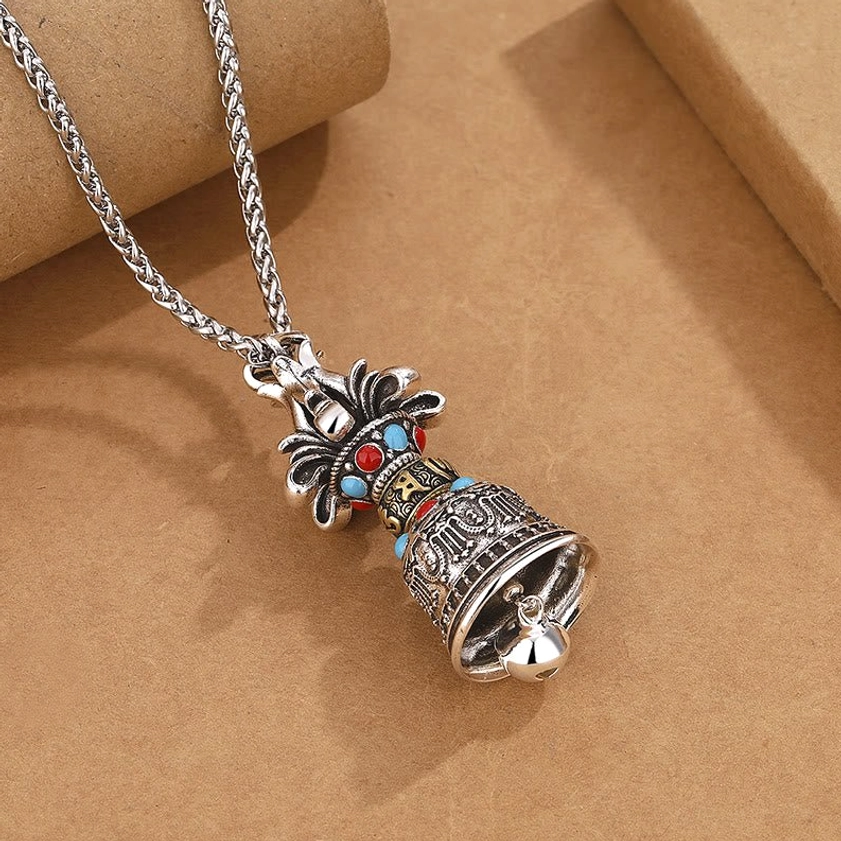 Buddhist Vajra pendant necklace right side view displaying rounded bell mouth and silver hanging bead detail
