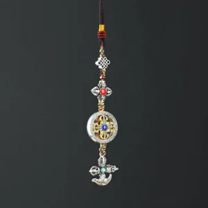 Buddhist vajra car hanging ornament with five-pronged design, silver metal finish, colorful braided cords and faux gemstones - top-down view