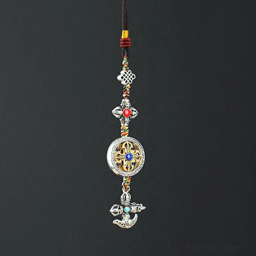 Buddhist vajra car hanging ornament with five-pronged design, silver metal finish, colorful braided cords and faux gemstones - top-down view