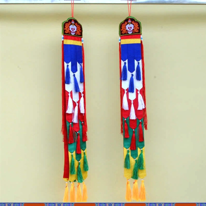 Buddhist wall hanging collection display showing multiple sacred symbol designs and variations