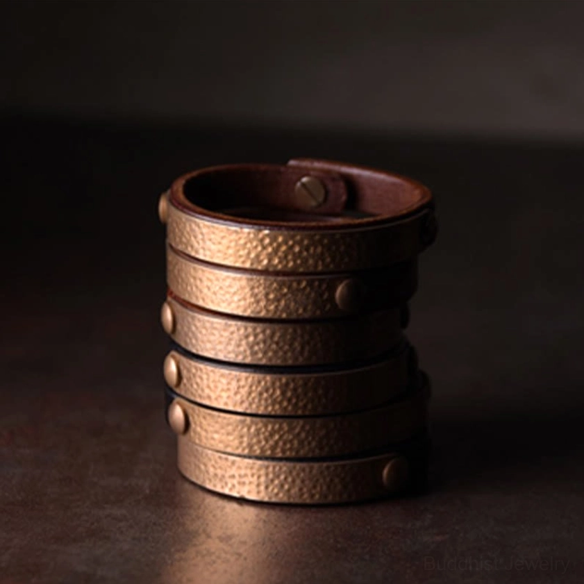 Handmade Buddhist wealth bangle with copper and brass materials showing traditional craftsmanship