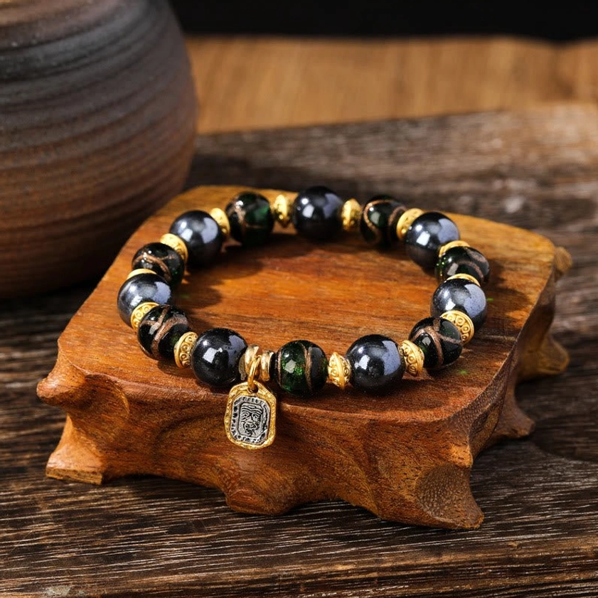 Blue-green toned Buddhist wealth bracelet featuring luminous Liuli glass beads in calming aquamarine hues for spiritual balance