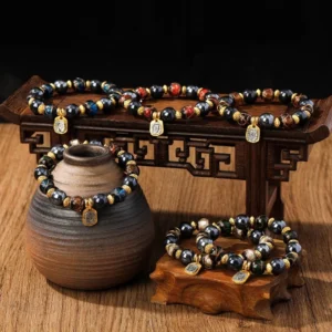 Collection of handcrafted Buddhist wealth goddess bracelets with multicolor Liuli glass beads and gold accents, displayed on traditional wooden table