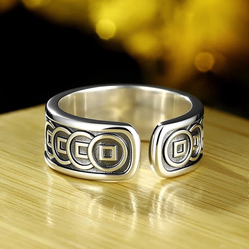 Top down flat view of Jambhala prosperity ring showing symmetrical coin pattern engravings on open band