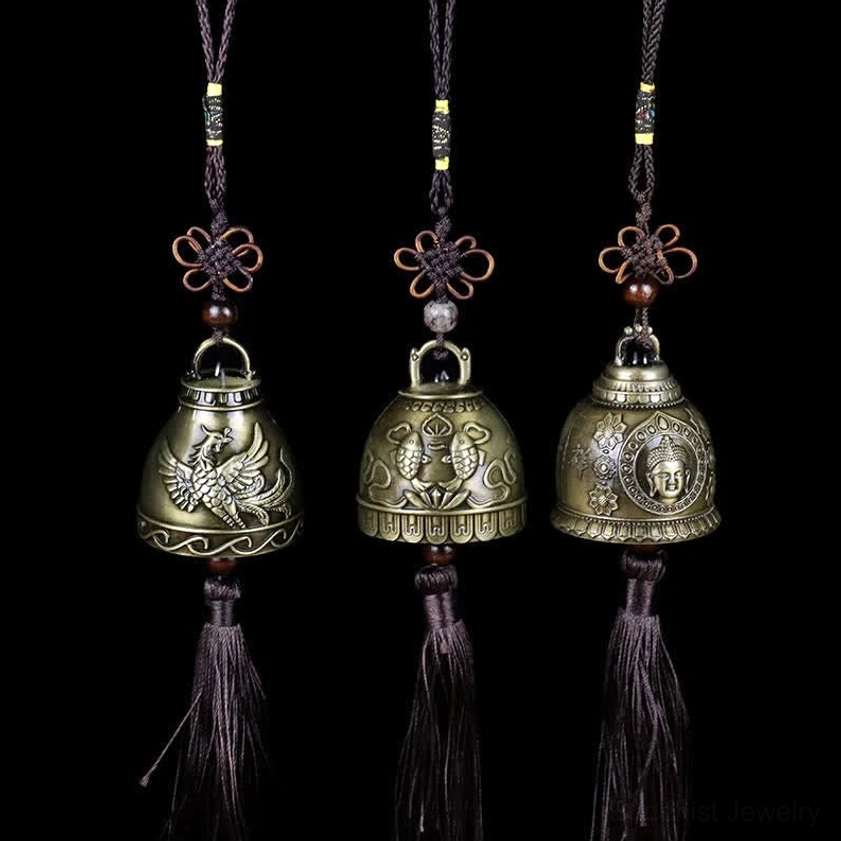 Three feng shui wind chime bells featuring Buddha, Phoenix, and Koi Fish designs with matching tassels