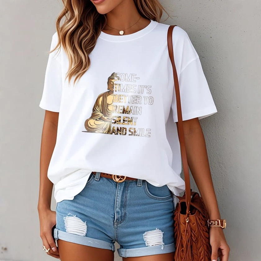 Female model wearing white Buddhist mindfulness graphic tee with distressed denim shorts, indoor casual styling