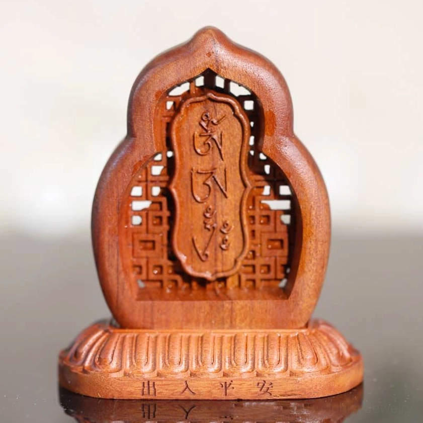 Buddhist wooden prayer plaque with carved inscriptions and traditional design elements