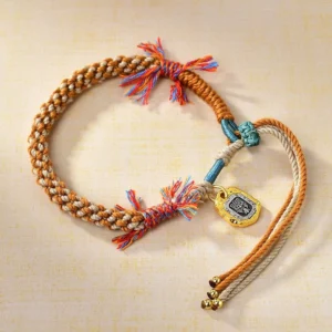 Colorful Buddhist string bracelet with Zakiram goddess charm, adjustable multicolor braided rope design featuring blue, red, green, yellow, and white strands with gold metal pendant and tassel details