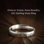 925 sterling silver Buddhist zodiac natal buddha couple ring with embossed zodiac symbol, overhead view on dark wood backdrop