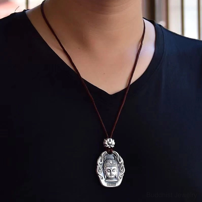 Buddhist zodiac pendant necklace collection display, showing multiple natal Buddha styles with brown cord and silver finish