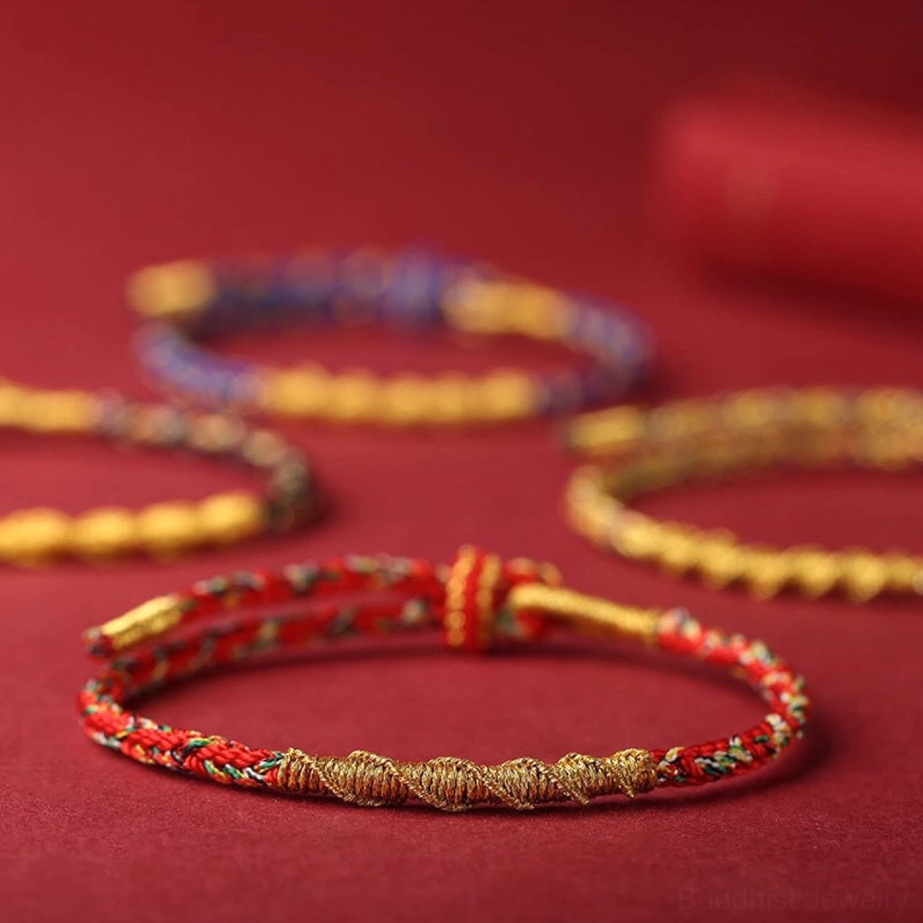 Assorted Buddhist zodiac red string bracelets collection in multiple color styles with twisted rope and gold accents