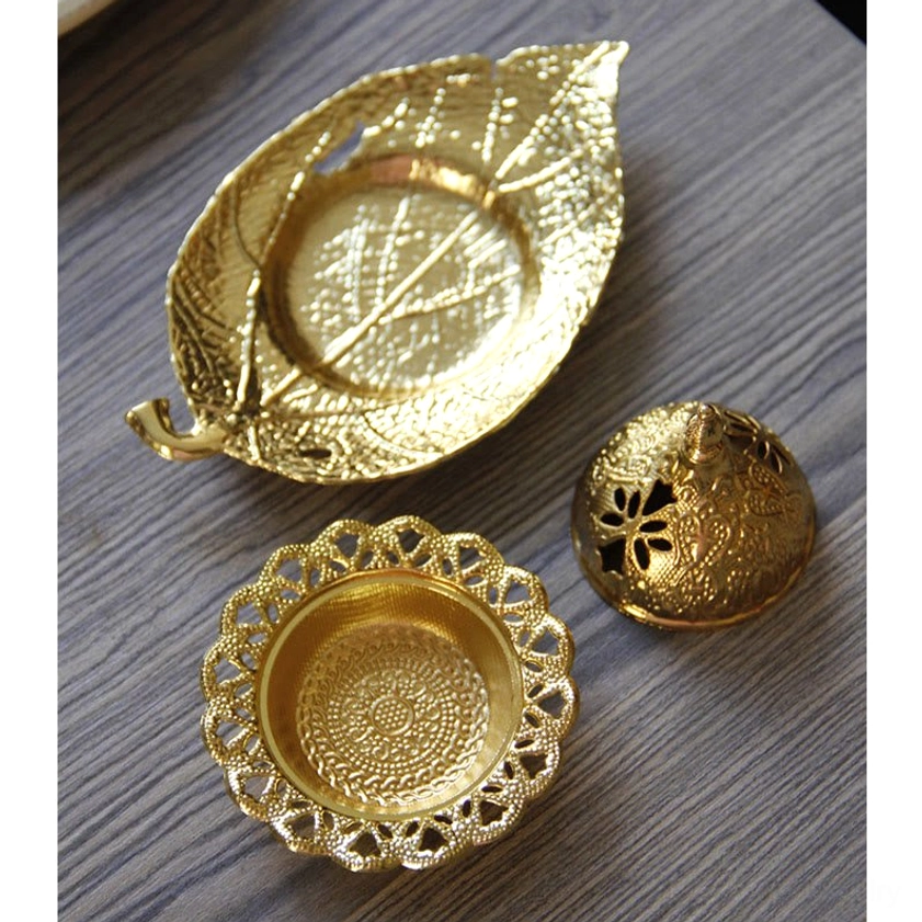 Disassembled incense burner components showing empty leaf tray, carved decorative plate and metal hollow lid