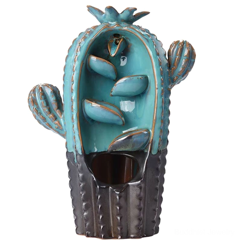 Eye-level frontal view of teal cactus incense burner with glazed finish and bronze accents on wooden table