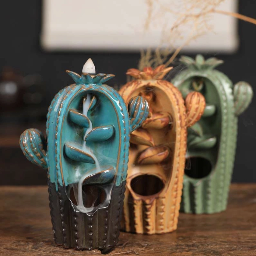 Collection of three color variants of cactus ceramic incense holders displayed together showing teal, green, and yellow options