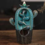 Teal ceramic cactus backflow incense burner with working smoke fountain effect on wooden surface