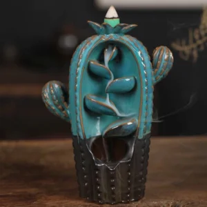 Teal ceramic cactus backflow incense burner with working smoke fountain effect on wooden surface