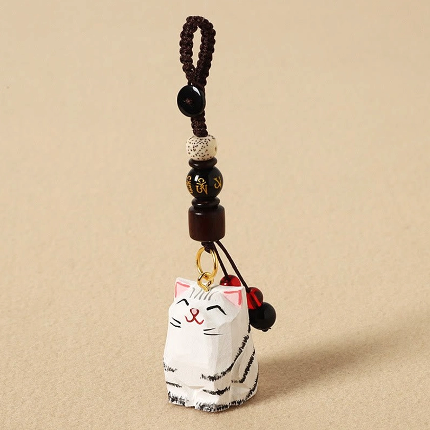 Calico cat Om Mani Padme Hum wooden keychain variant flat lay showing unique feline carving style
