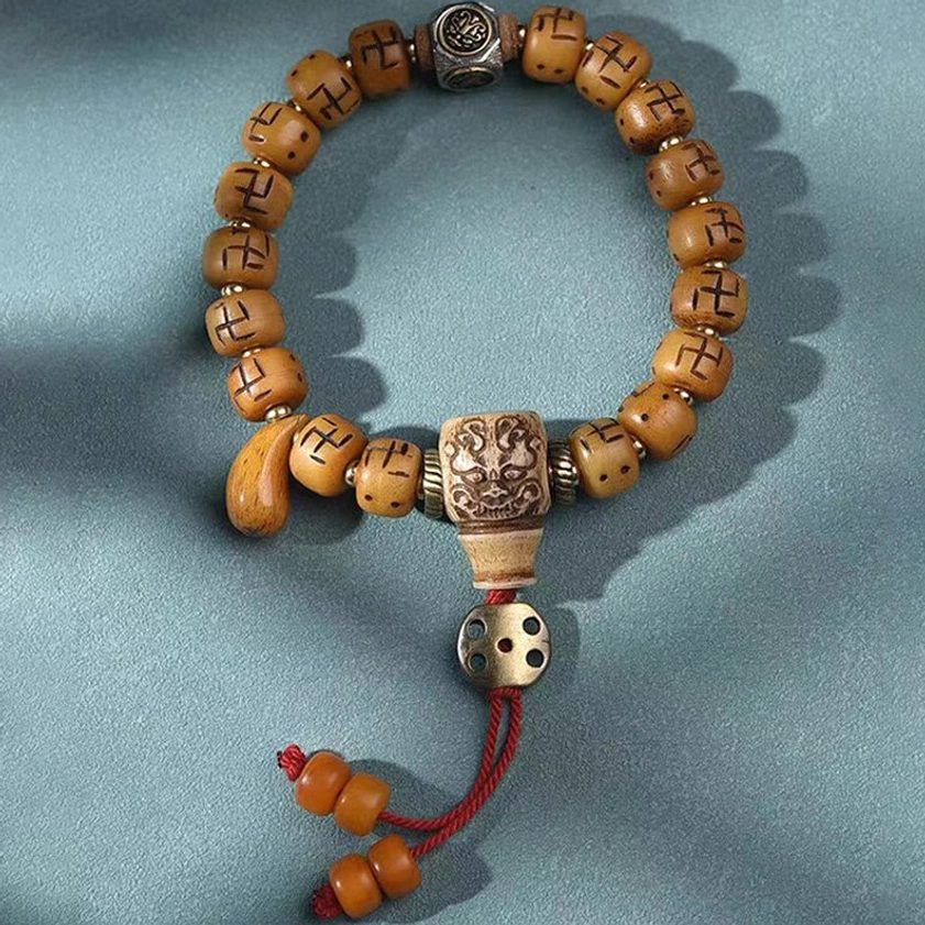 Camel bone Buddhist prayer bracelet with multiple sacred symbols, spiritual beads, and traditional woven accent